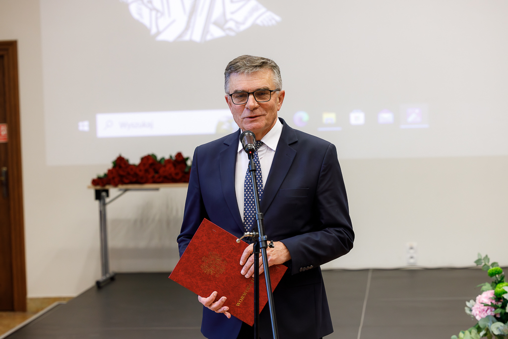 Wojewoda lubelski Lech Sprawka przed mikrofonem. Trzyma teczkę.