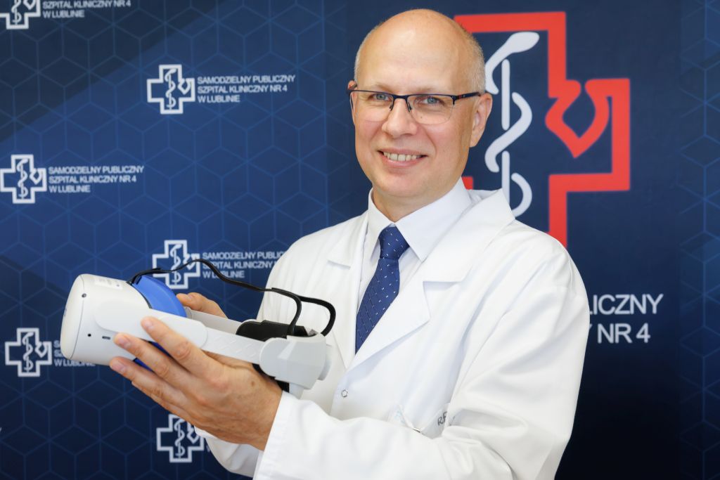 Prof. Tomasz Blicharski trzymający okulary VR