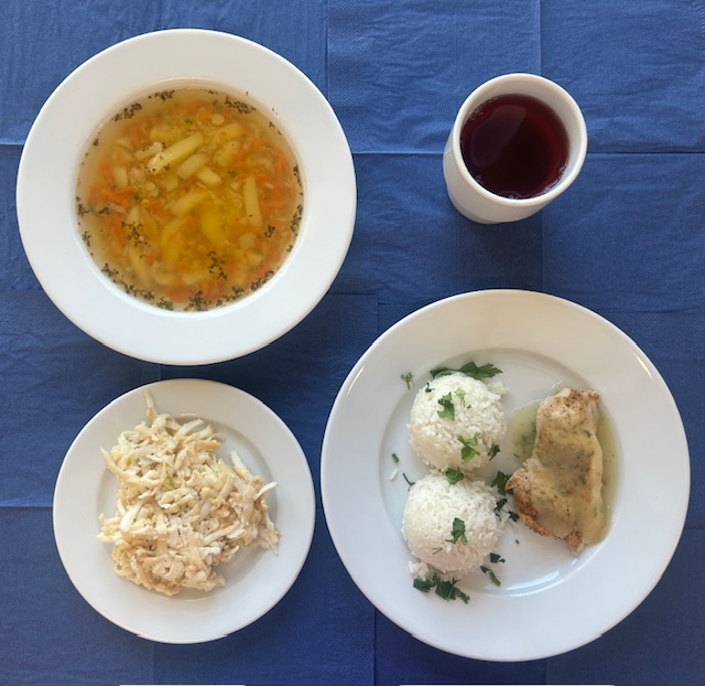 na talerzach zupa grochowa, bitka drobiowa, sos koperkowy, ryż basmati, surówka z selera i jabłka z jogurtem, w kubku kompot 